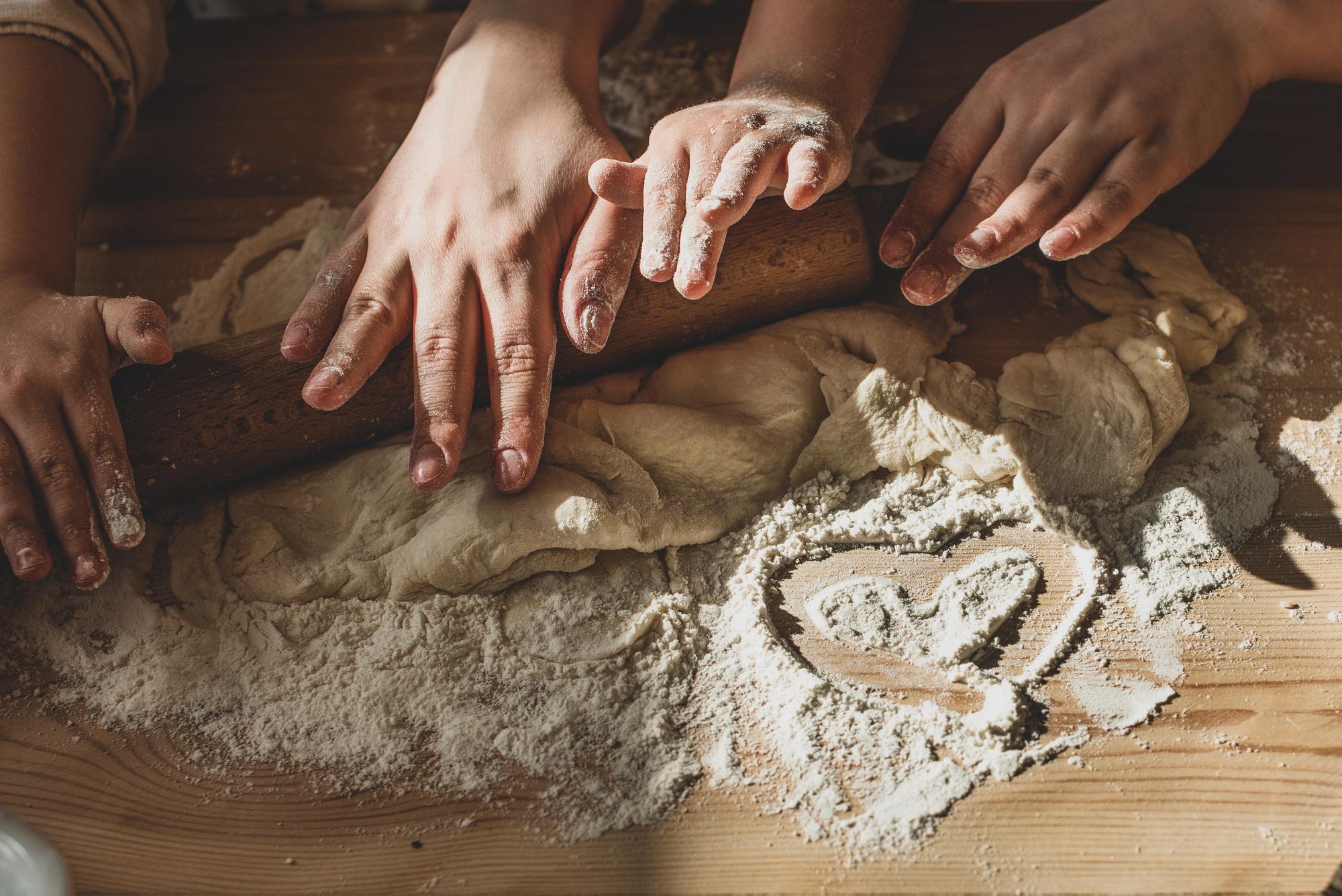 Hands preparing dough in a class